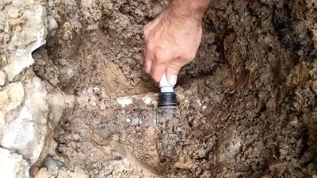 Measuring short pex water line repair piece during residential plumbing work in Kingman, AZ